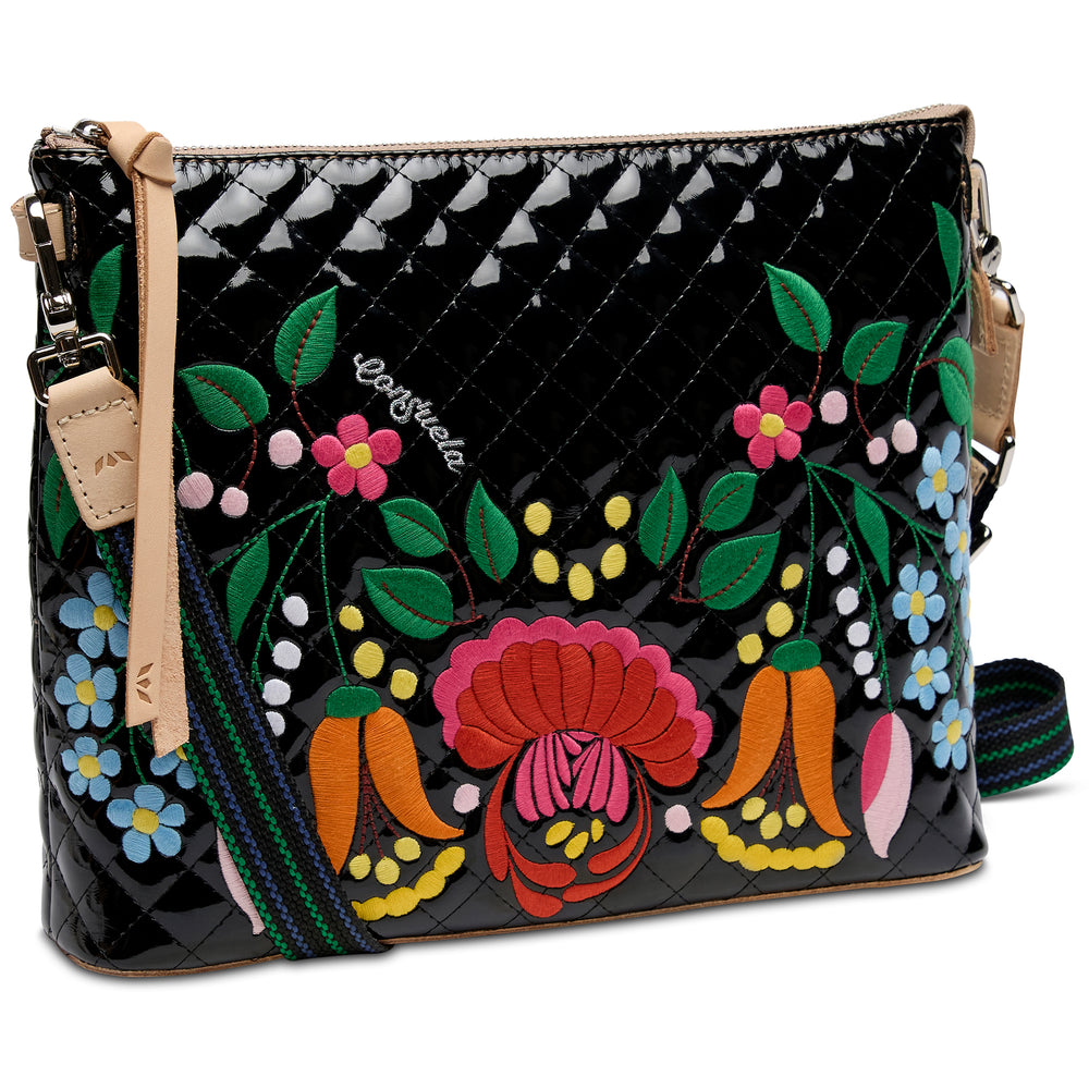 Colorful floral and leaf patterned handbag with a black background