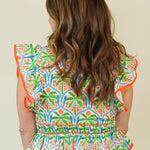 Dalila Tropical Print Peplum Top with Front Ties on model with white shorts back detail 
