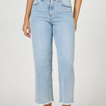Light blue jeans worn by a person on a white background