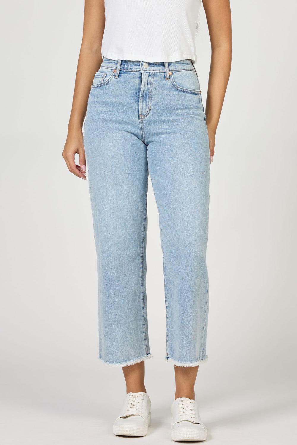 Light blue jeans worn by a person on a white background