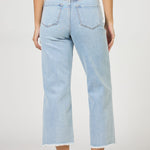 Light blue jeans worn by a person on a white background