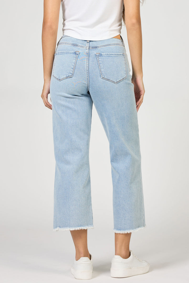 Light blue jeans worn by a person on a white background