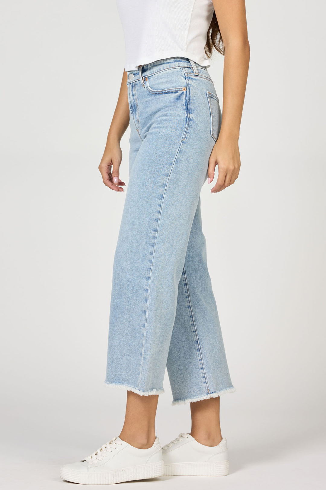 Light blue jeans worn by a person on a white background