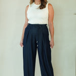 Woman wearing navy wide leg drawstring pants with white tee 