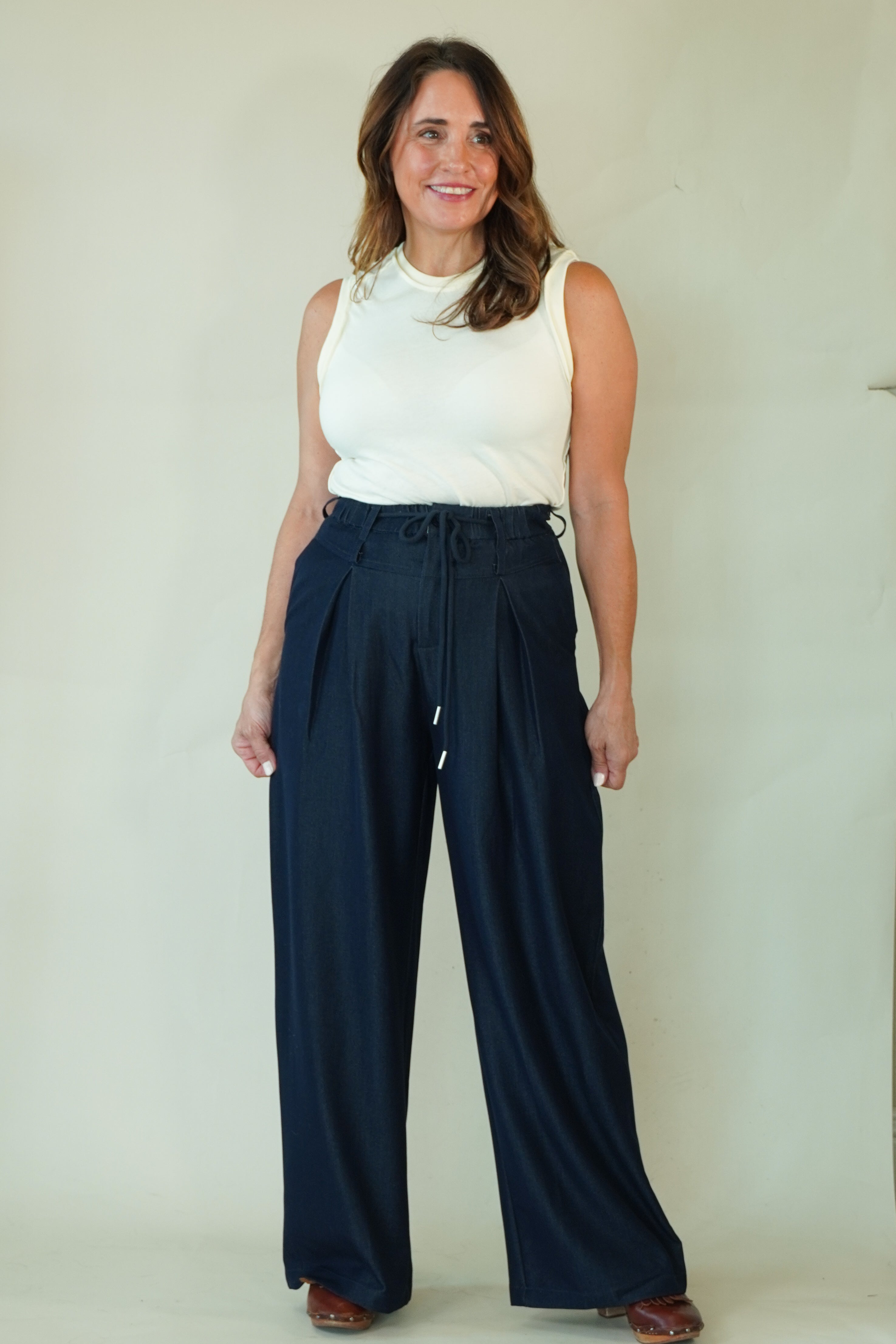 Woman wearing navy wide leg drawstring pants with white tee 