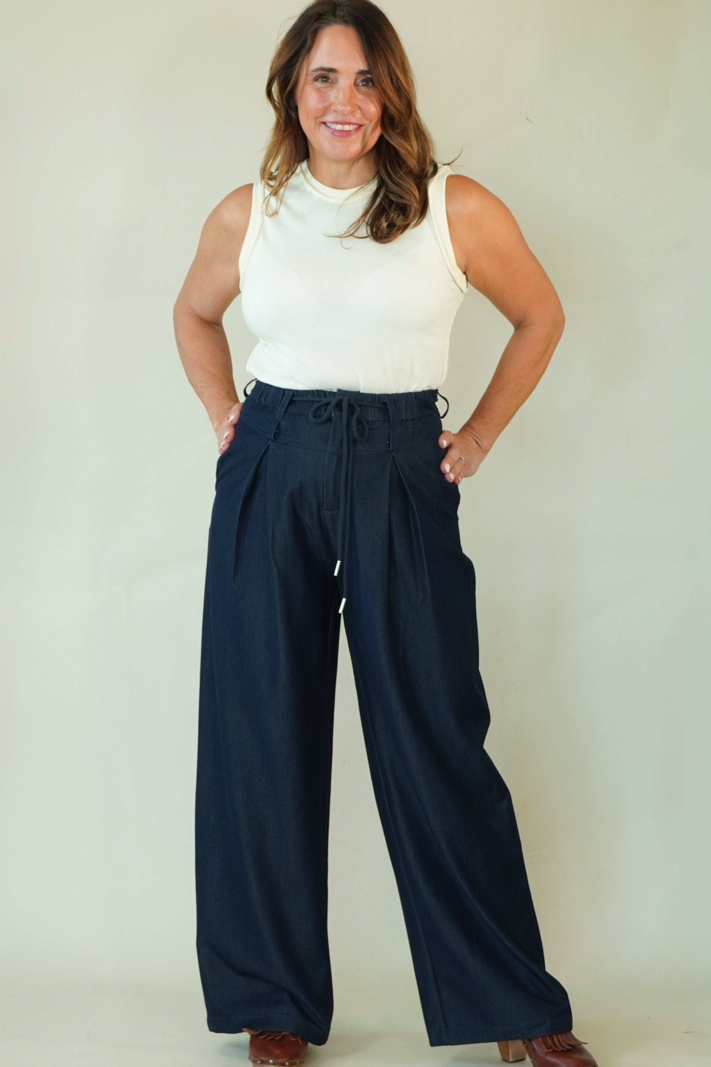 Woman wearing navy wide leg drawstring pants with white tee 