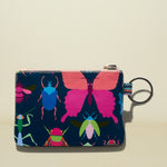 Small pouch with colorful insect design on a beige background
