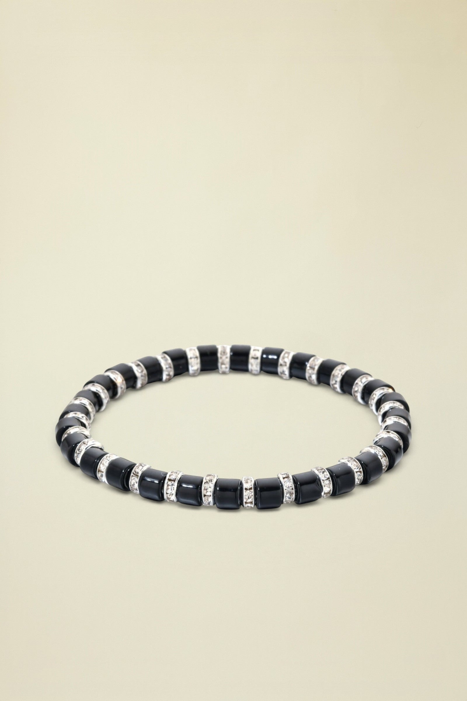 Black beaded bracelet with silver accents on a white background