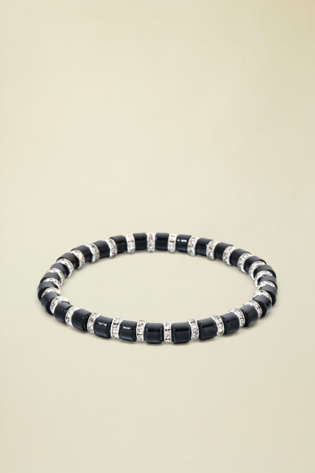 Black beaded bracelet with silver accents on a white background