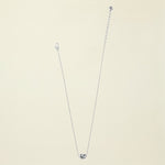 Silver necklace with a heart pendant on a white background