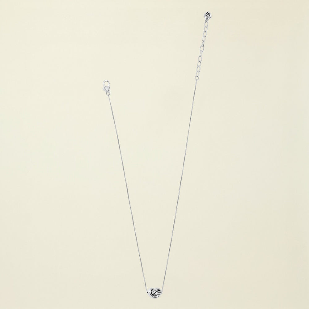 Silver necklace with a heart pendant on a white background