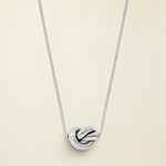 Silver knot pendant necklace on a white background