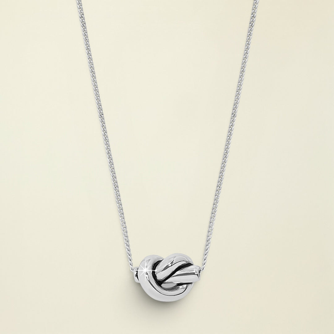 Silver knot pendant necklace on a white background
