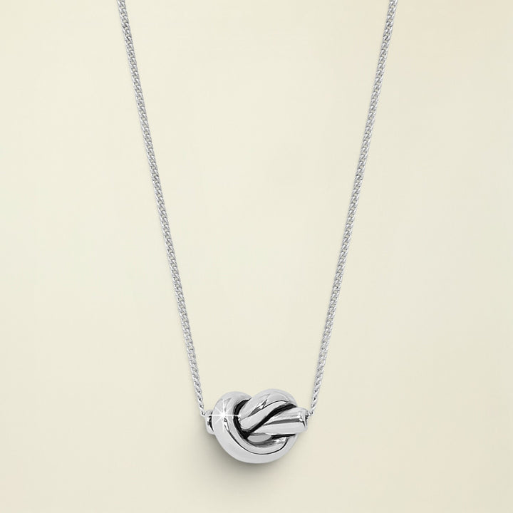 Silver knot pendant necklace on a white background