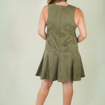 Woman wearing olive suede racing stripe dress with tan wedges back view of dress