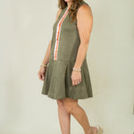 Woman wearing olive suede racing stripe dress with tan wedges
