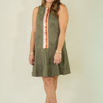 Woman wearing olive suede racing stripe dress with tan wedges