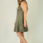 Woman wearing olive suede racing stripe dress with tan wedges