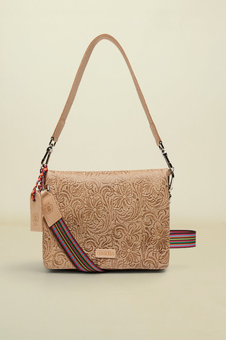 Beige handbag with floral patterns and a colorful strap on a white background