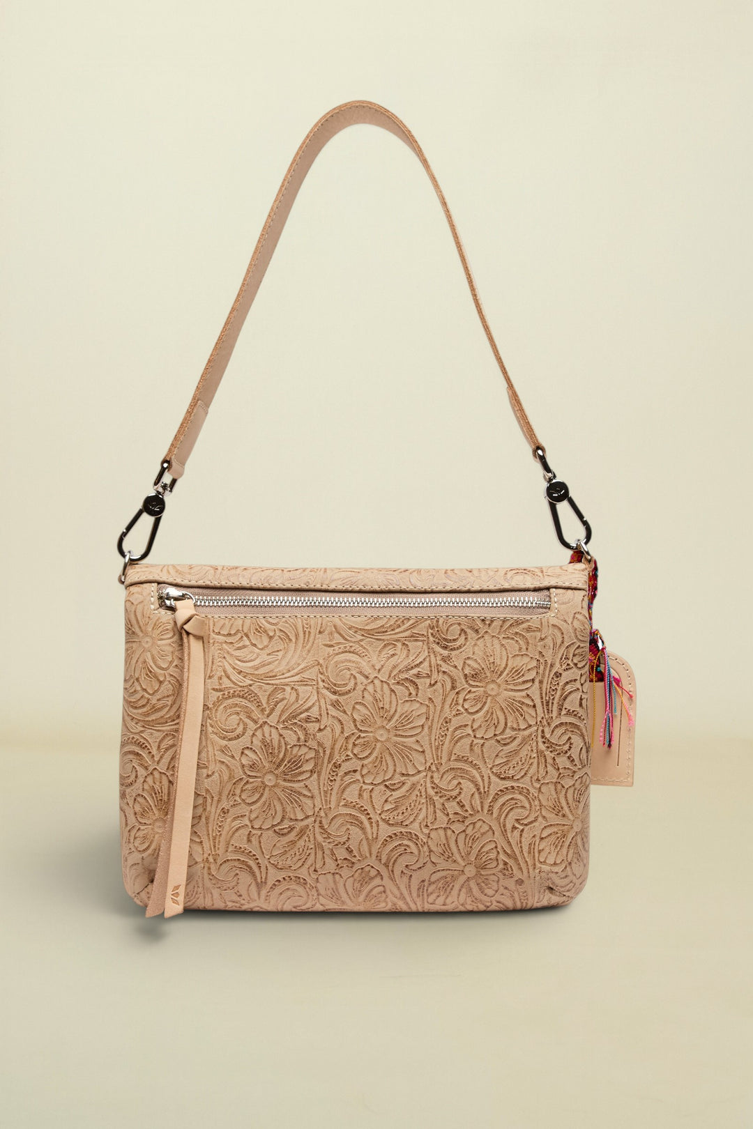 Beige floral-patterned handbag with a strap on a white background