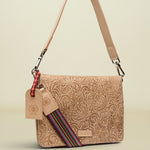 Beige patterned handbag with a strap and tag on a white background