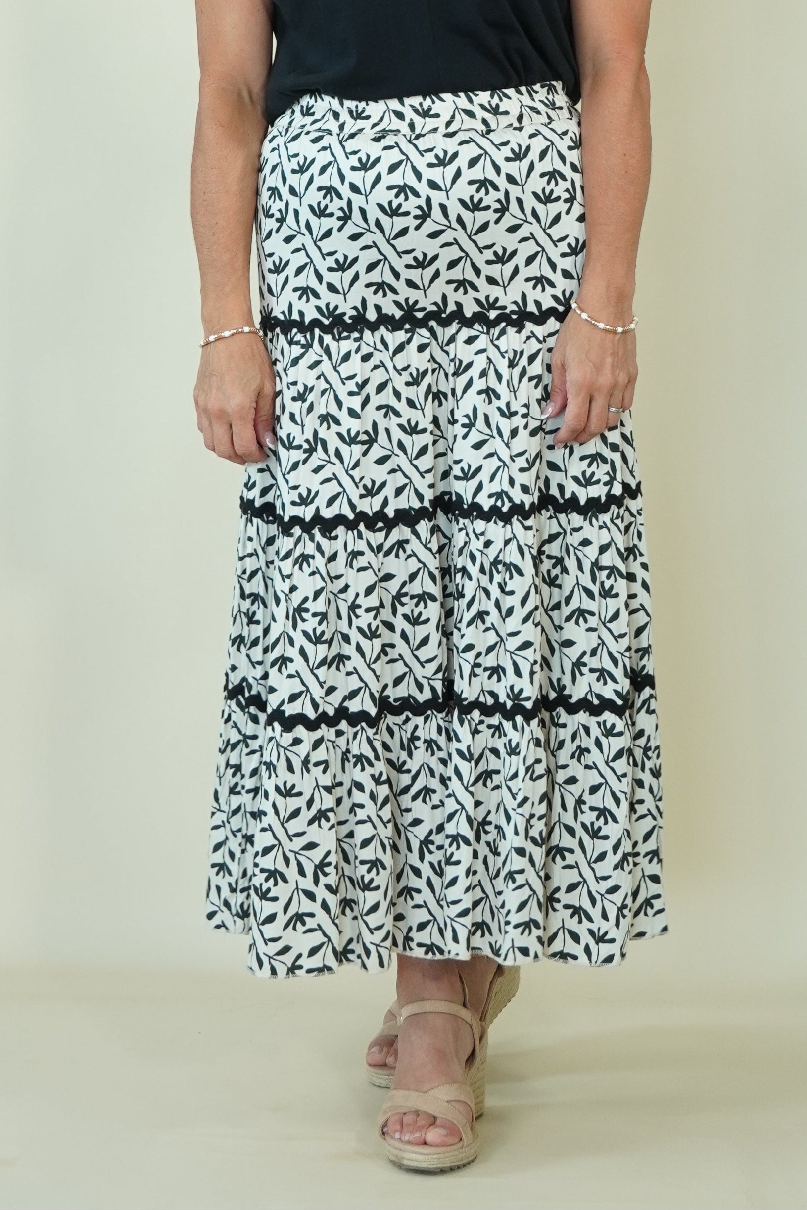 Lucia Leaf Print Tiered Skirt on woman with a black top 