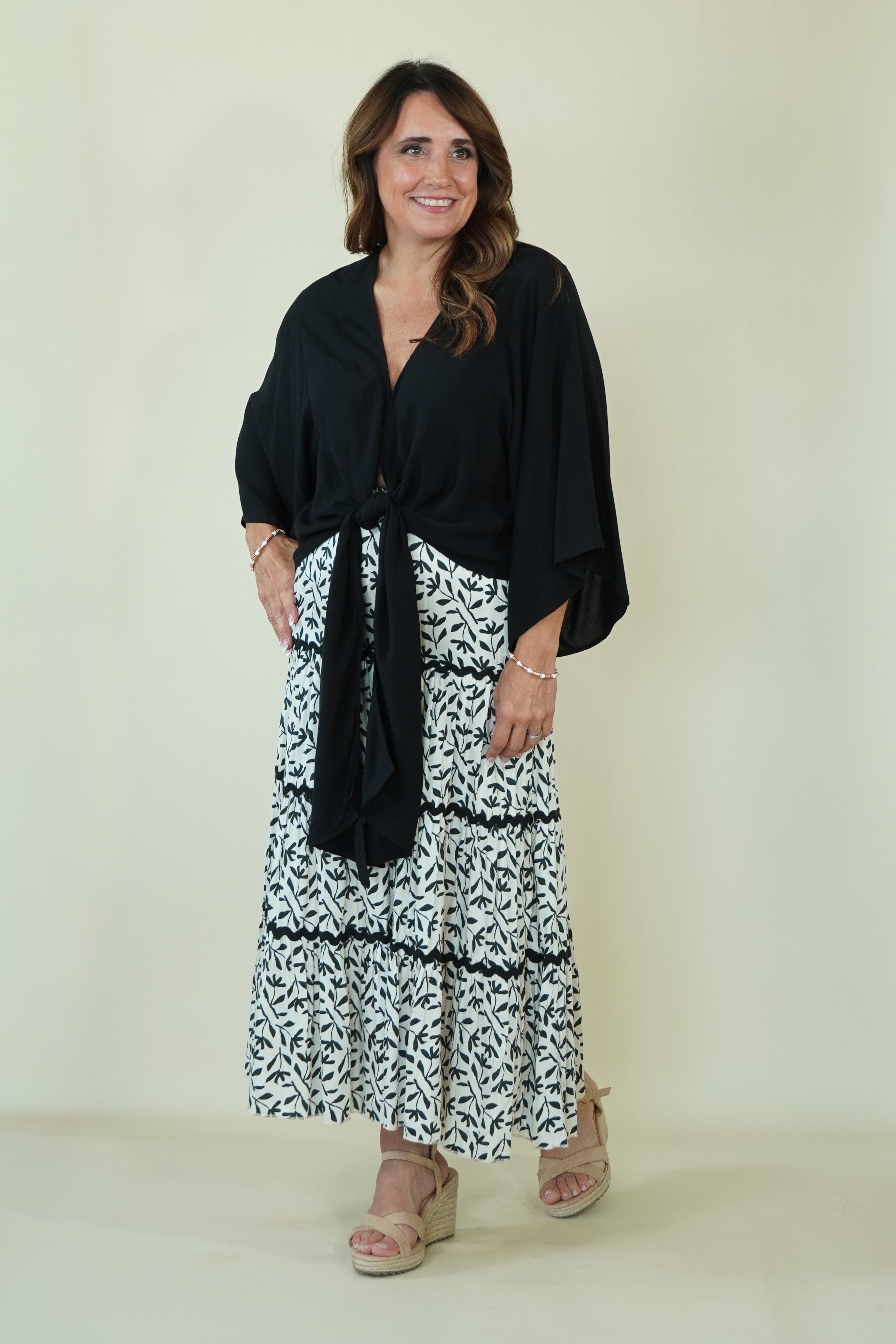 Lucia Leaf Print Tiered Skirt with tie front black top on model 