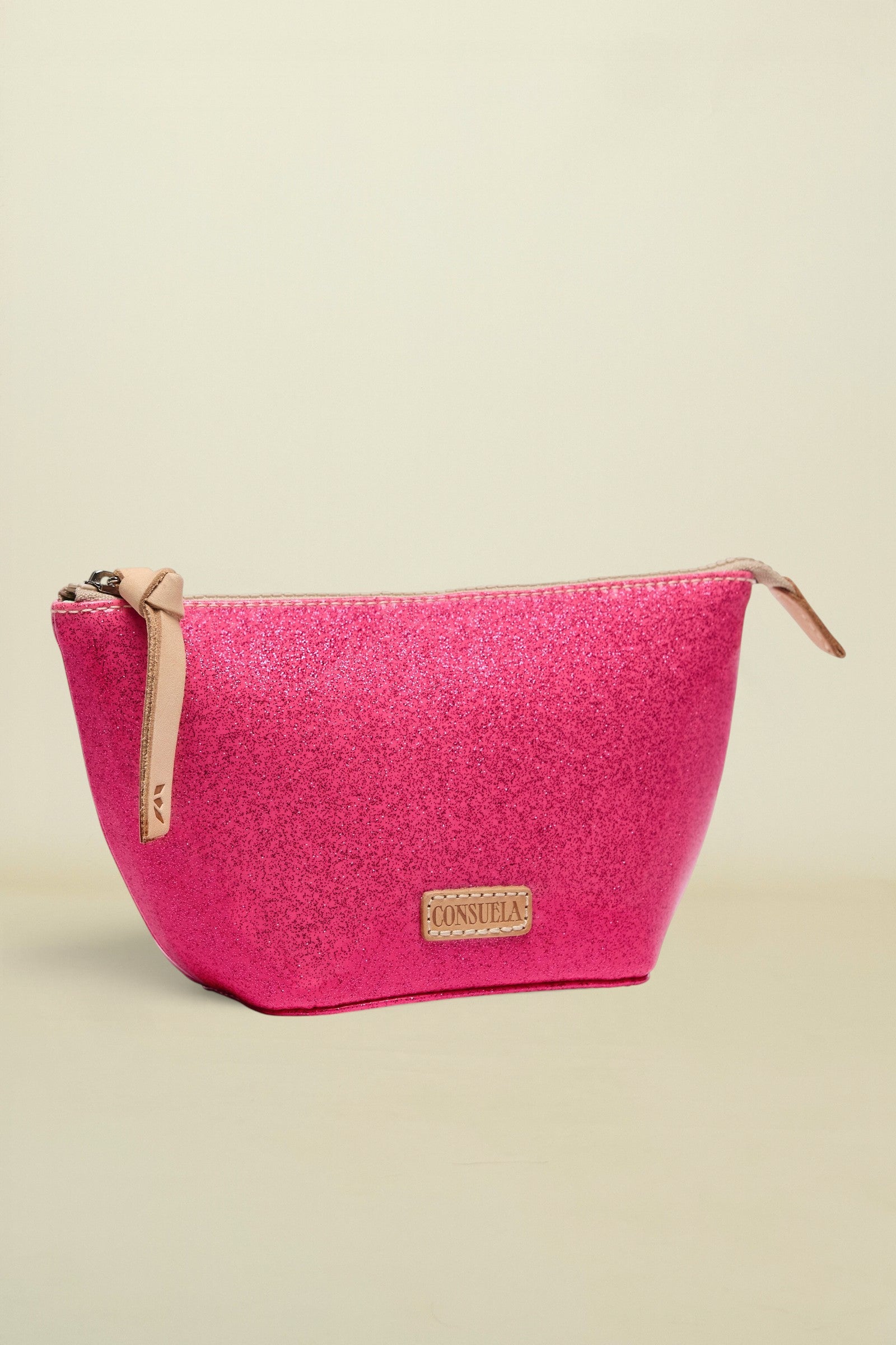 Pink textured pouch with beige zipper and 'Consuela' brand logo on a white background