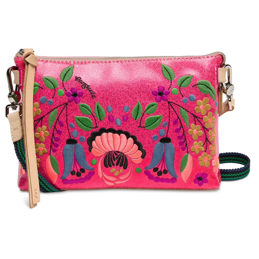 Pink crossbody bag with floral designs on a white background