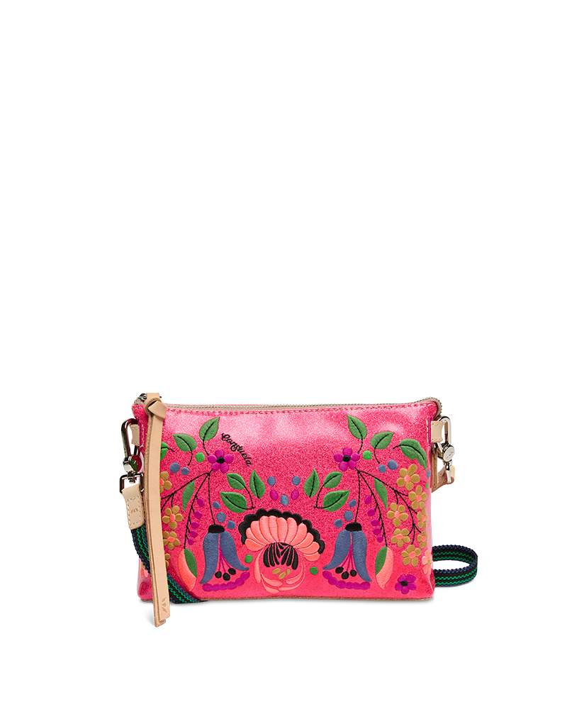 Pink handbag with floral and ethnic designs on a white background