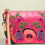 Pink handbag with floral and ethnic designs on a white background