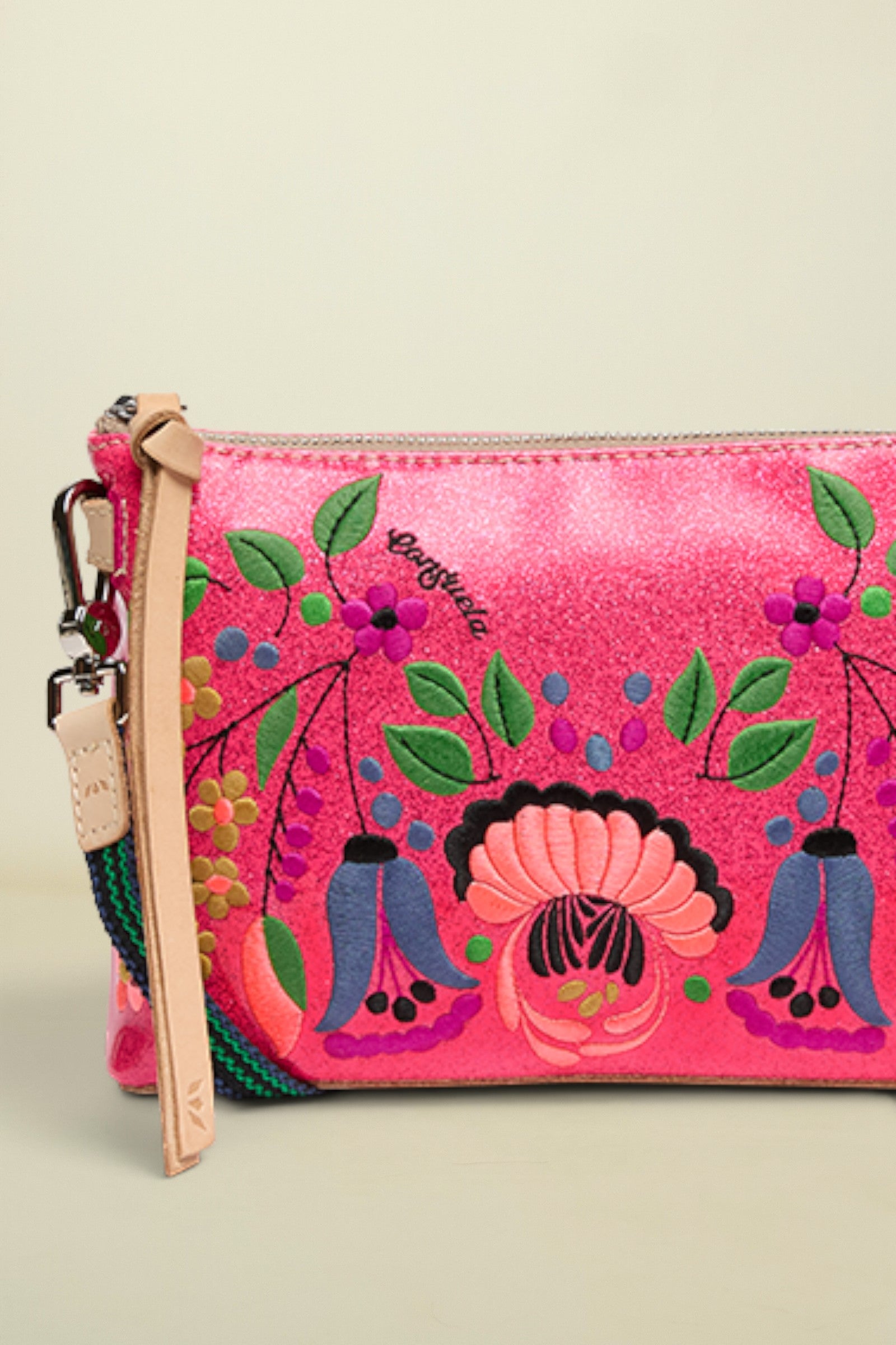 Pink handbag with floral and ethnic designs on a white background