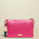 Pink crossbody bag with a visible brand logo on a white background