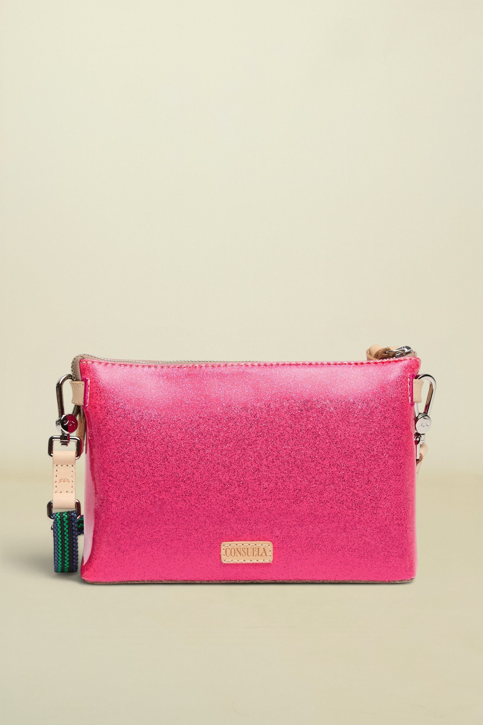 Pink crossbody bag with a visible brand logo on a white background