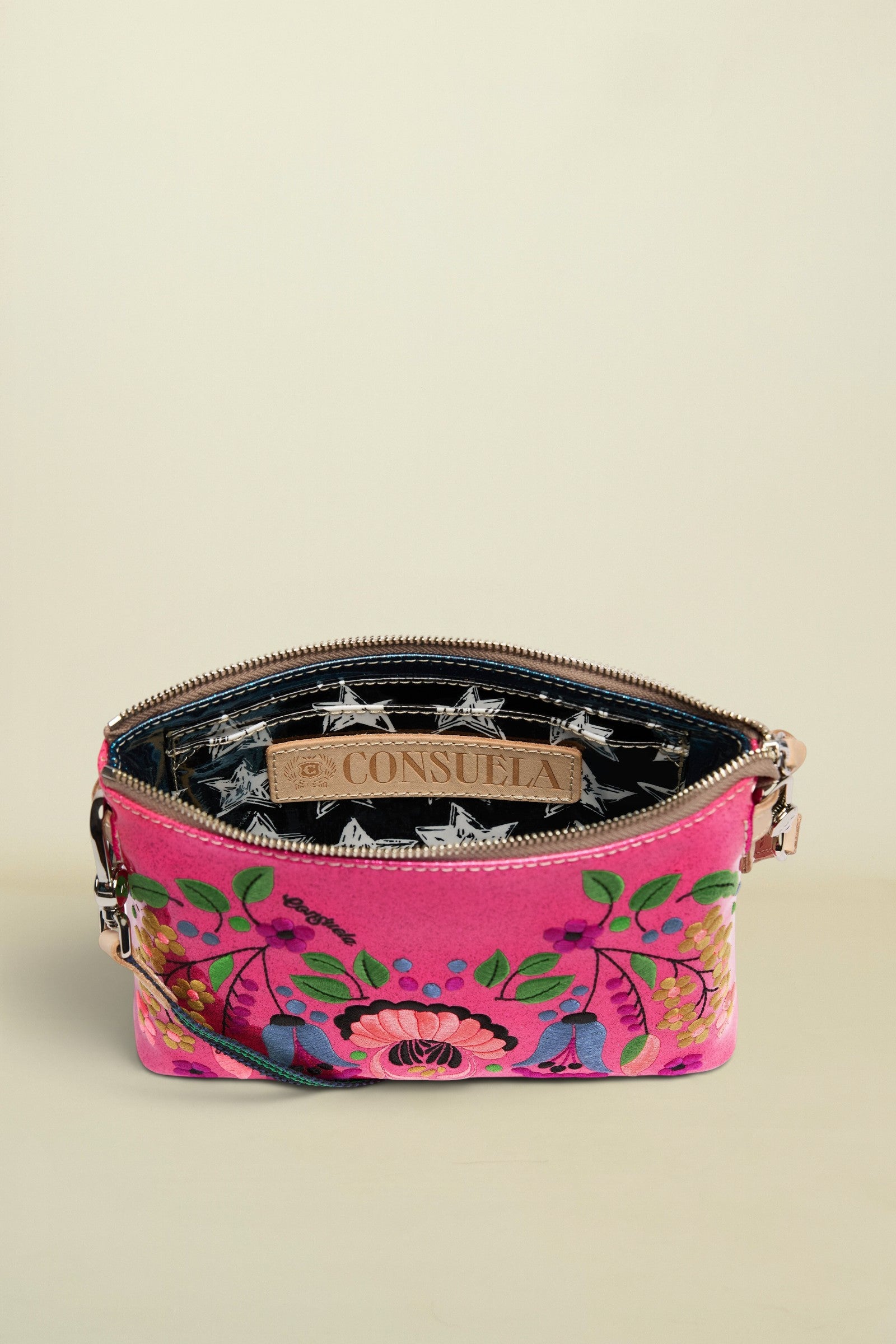 Pink floral handbag with a visible brand label on a white background