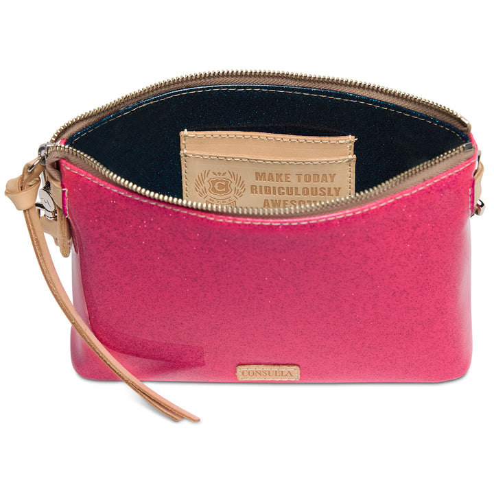 Pink clutch bag with beige strap and visible brand logo on a white background