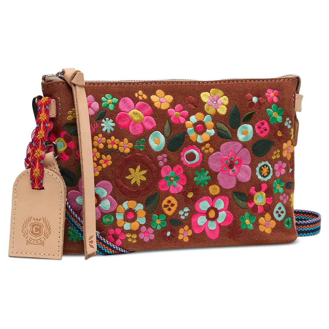 Brown leather clutch with colorful floral embroidery on a white background