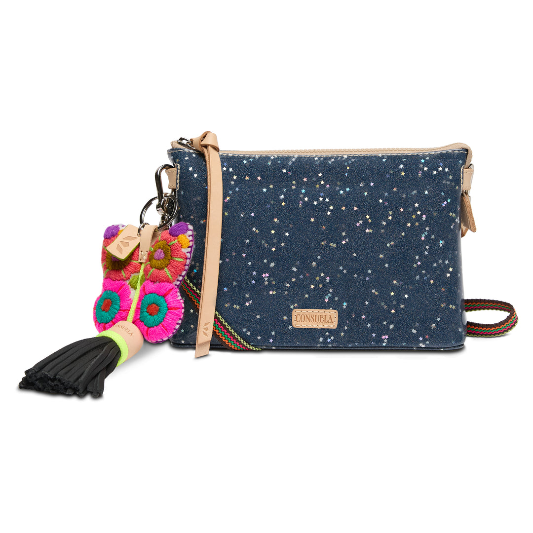 Blue clutch bag with floral keychain and tassel on a white background