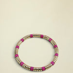 Bracelet with pink and gold beads on a white background