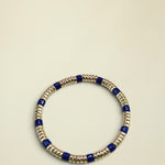 Beaded bracelet with blue and gold beads on a white background