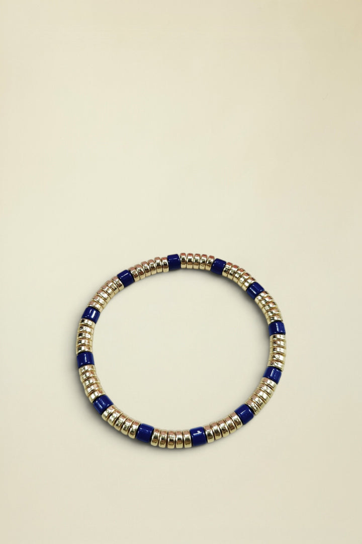 Beaded bracelet with blue and gold beads on a white background