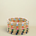 Stack of colorful beaded bracelets on a white background