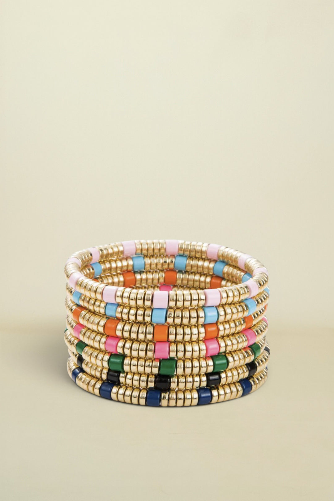 Stack of colorful beaded bracelets on a white background