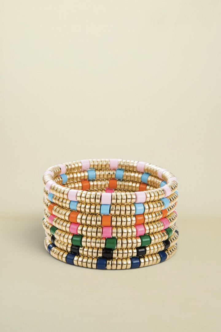 Stack of colorful beaded bracelets on a white background