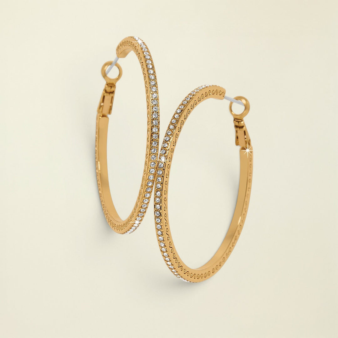 Gold hoop earrings with embedded stones on a white background