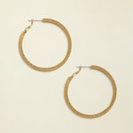 Gold hoop earrings on a white background