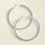 Meridian Thin Large Hoop Earrings laying on neutral background