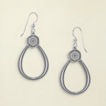 Pair of silver earrings with hexagonal design on a white background