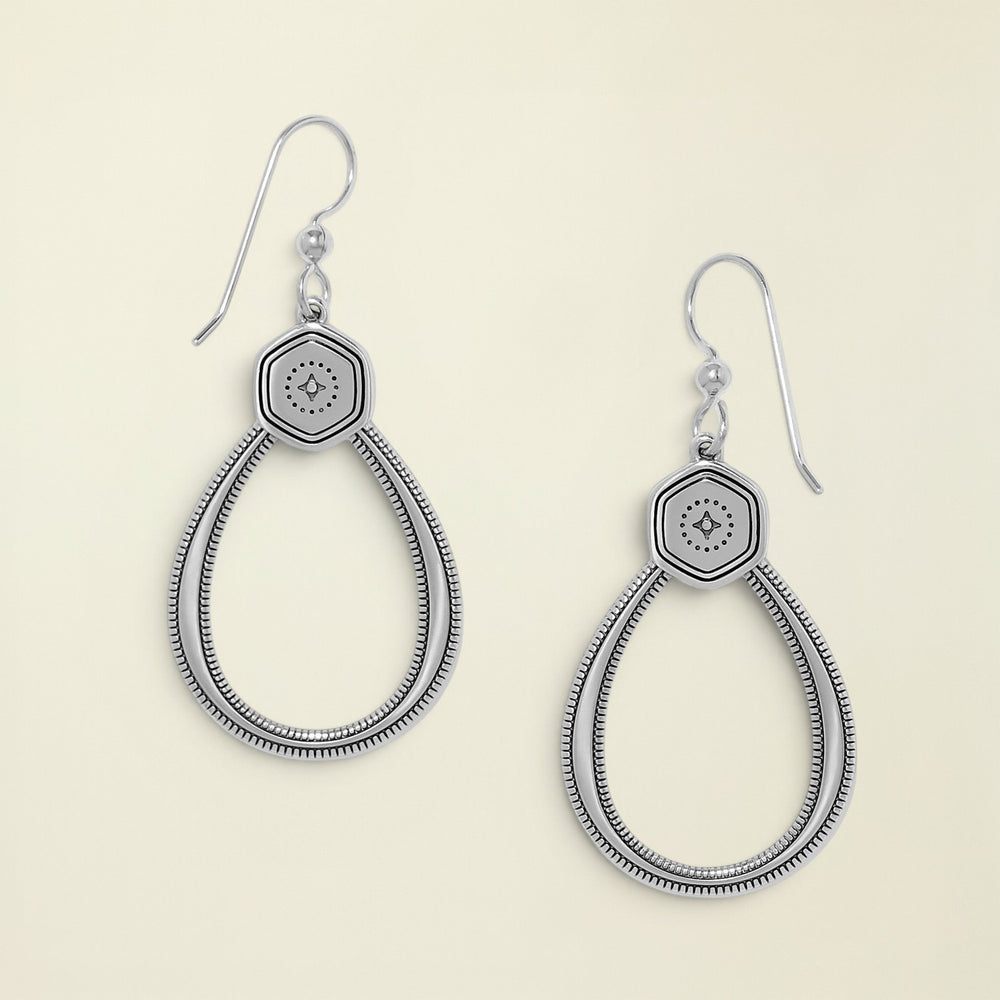 Pair of silver earrings with hexagonal design on a white background