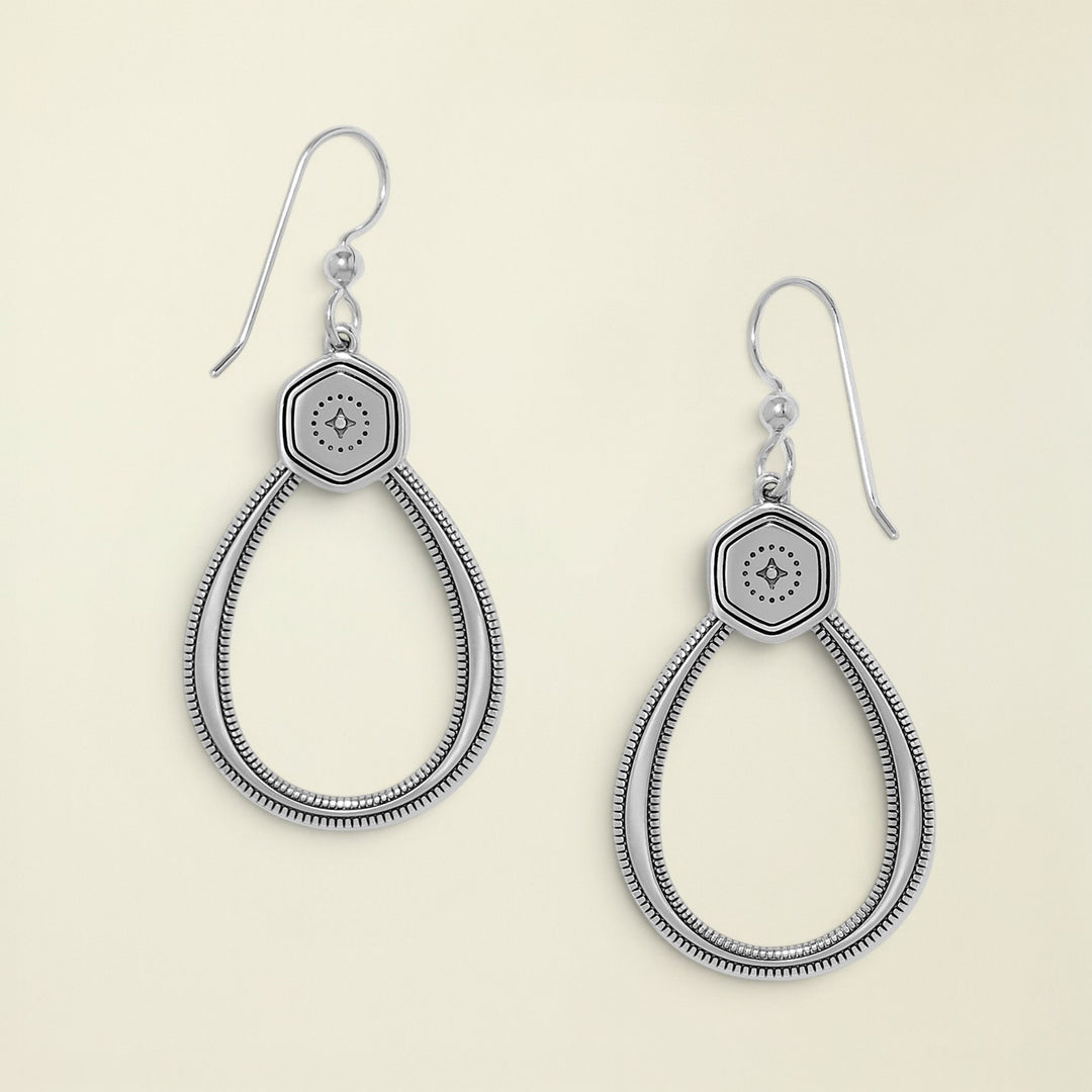Pair of silver earrings with hexagonal design on a white background